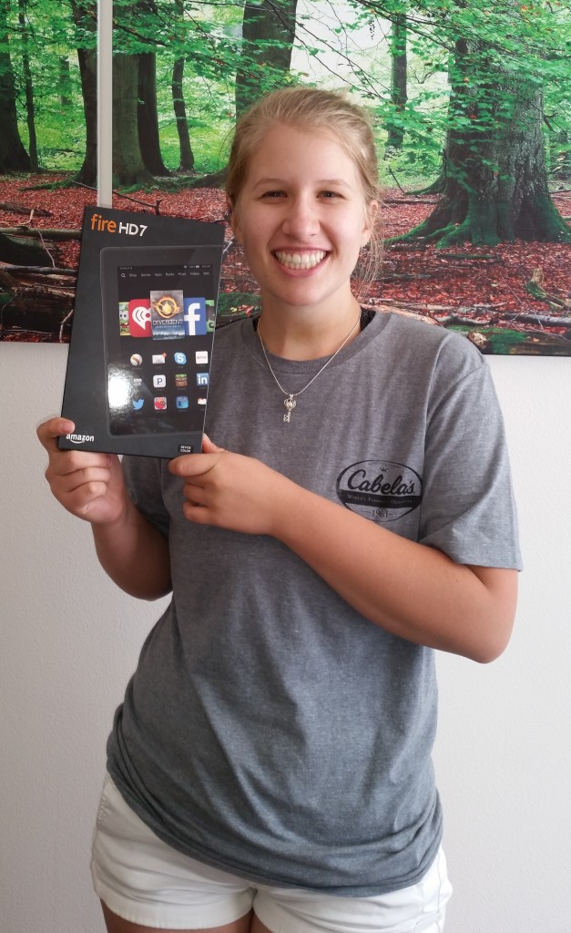 Photo of winner Stacey Marks holding her Kindle Fire